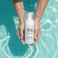Person holding a bottle of 'Avry1 Pretty' prerfect foaming face wash in water